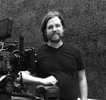 Zachary Taylor beside a cinema camera